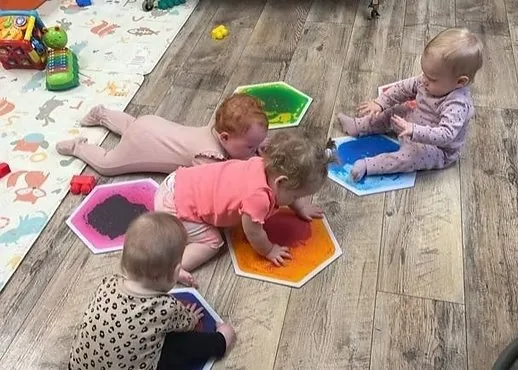 Infants exploring colorful sensory mats
