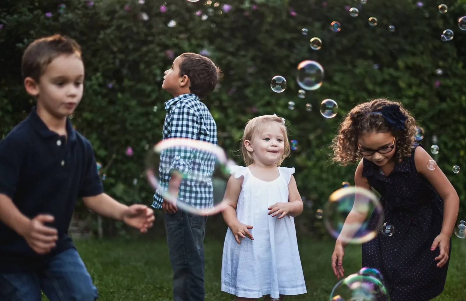 Children playing with bubbles outdoors