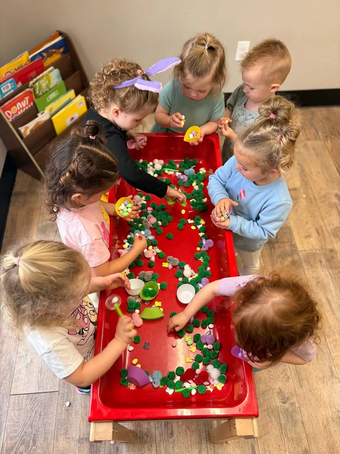 Toddlers exploring at sensory table