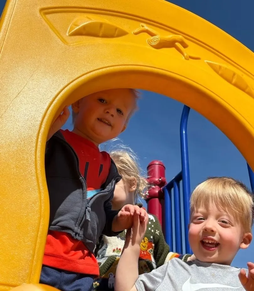 Children playing on outdoor playground equipment